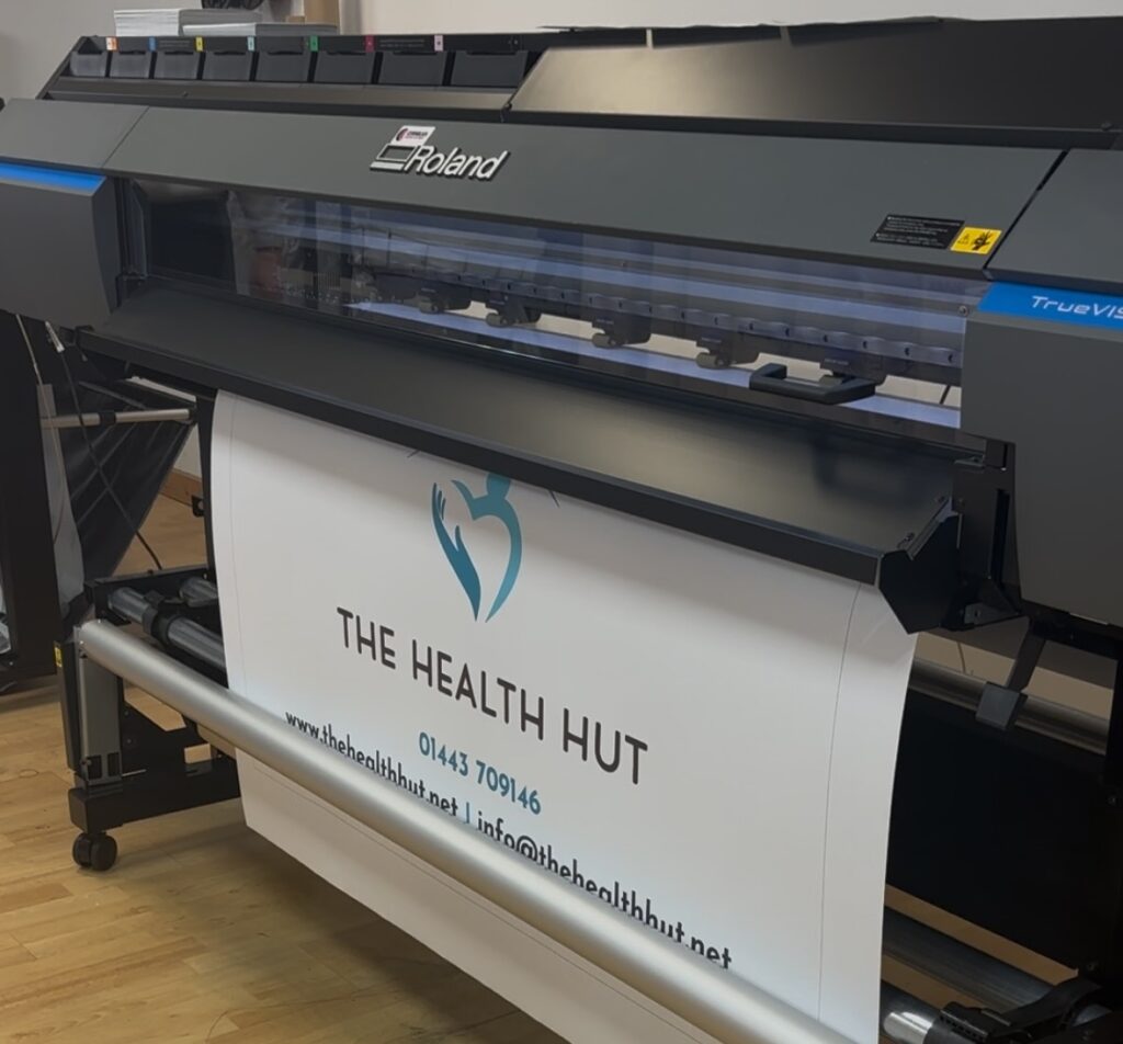 An image of a Roland printer printing a large format sign.  